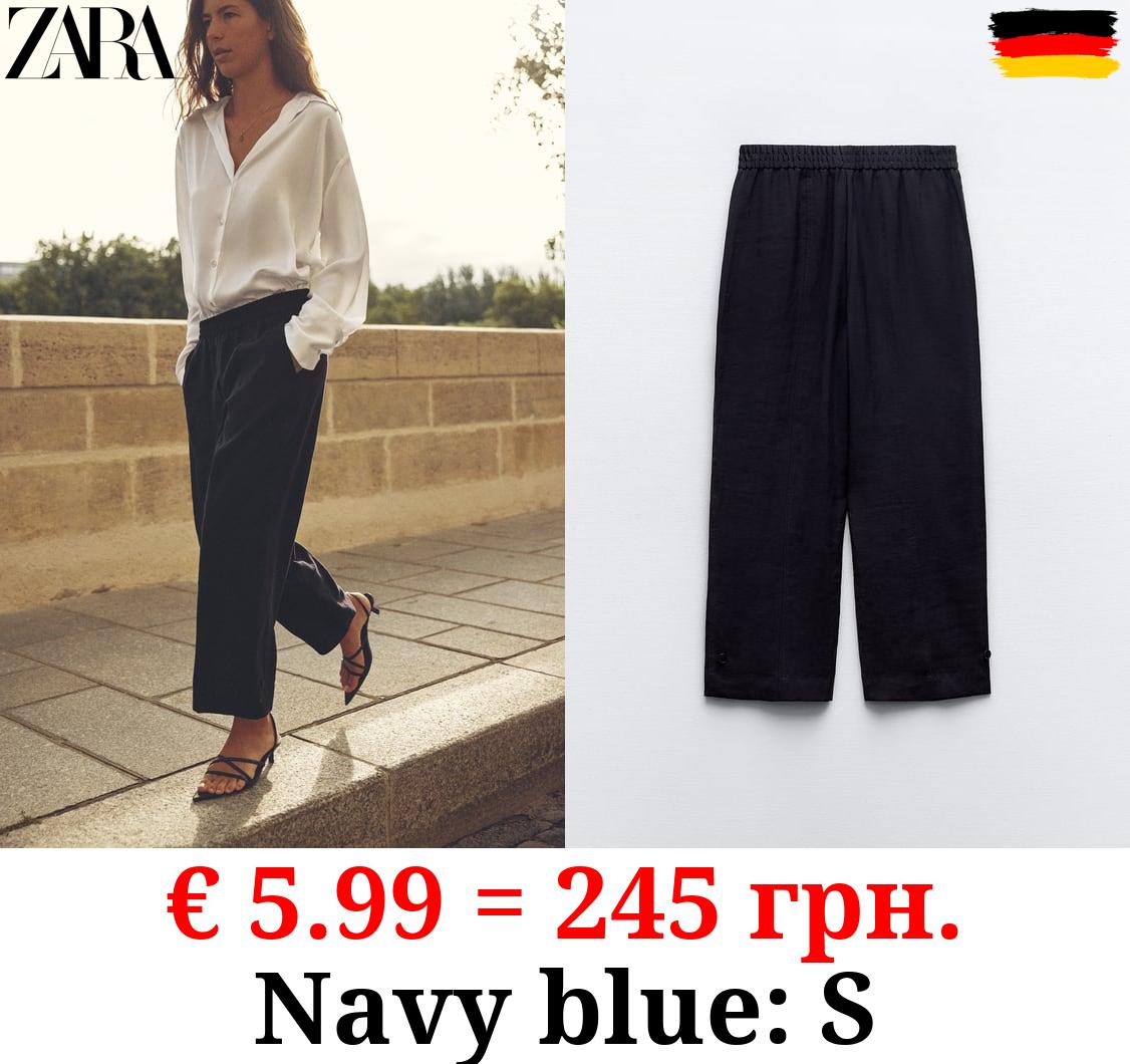 CARROT FIT TROUSERS WITH TABS AT HEM