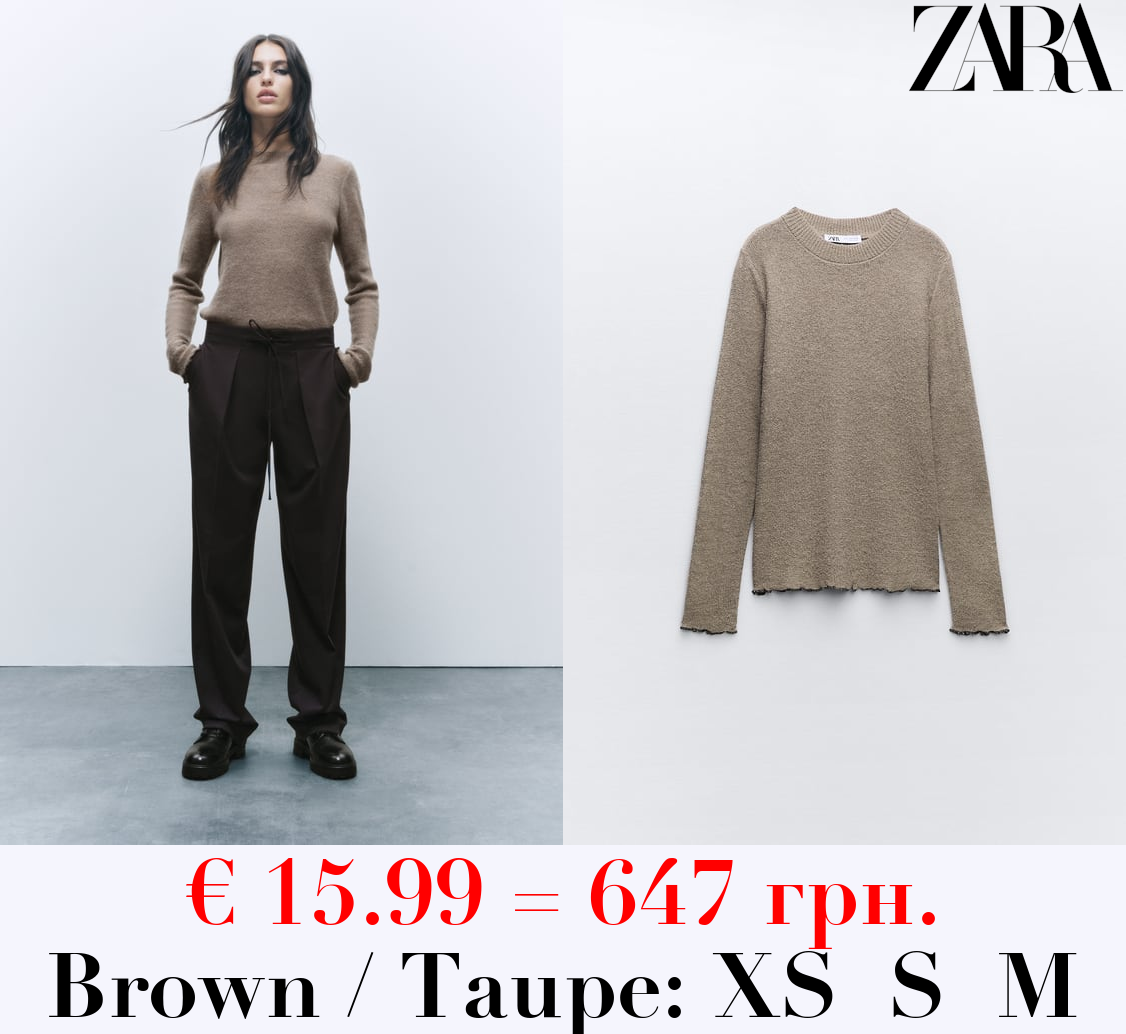 KNIT SWEATER WITH ROLLING TRIMS