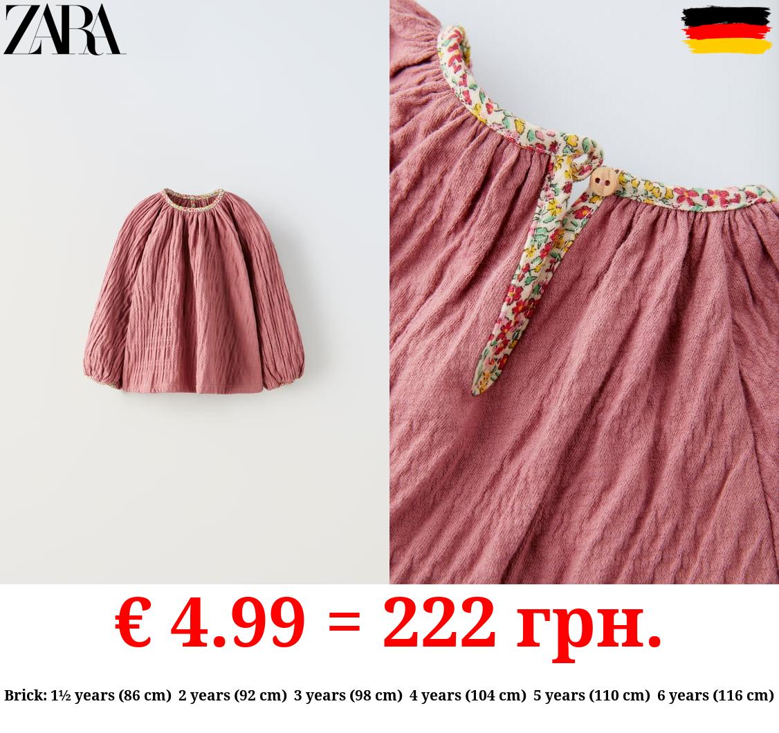 CREPE OVERSIZE BLOUSE WITH FLORAL TRIM