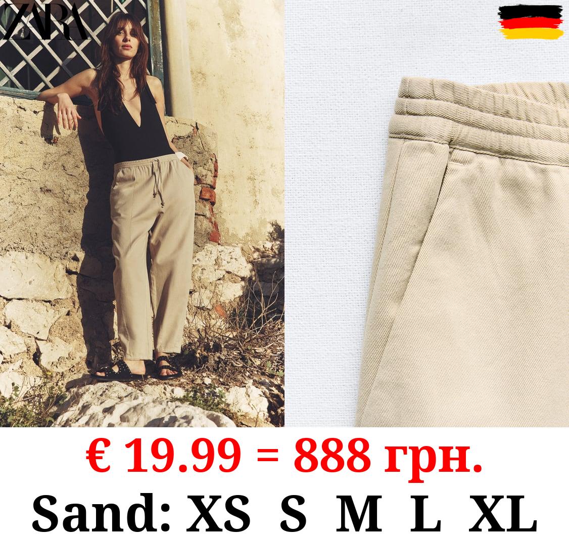 TROUSERS WITH AN ELASTICATED WAISTBAND