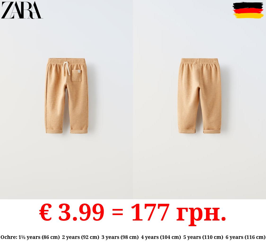 TEXTURED TROUSERS WITH LABEL