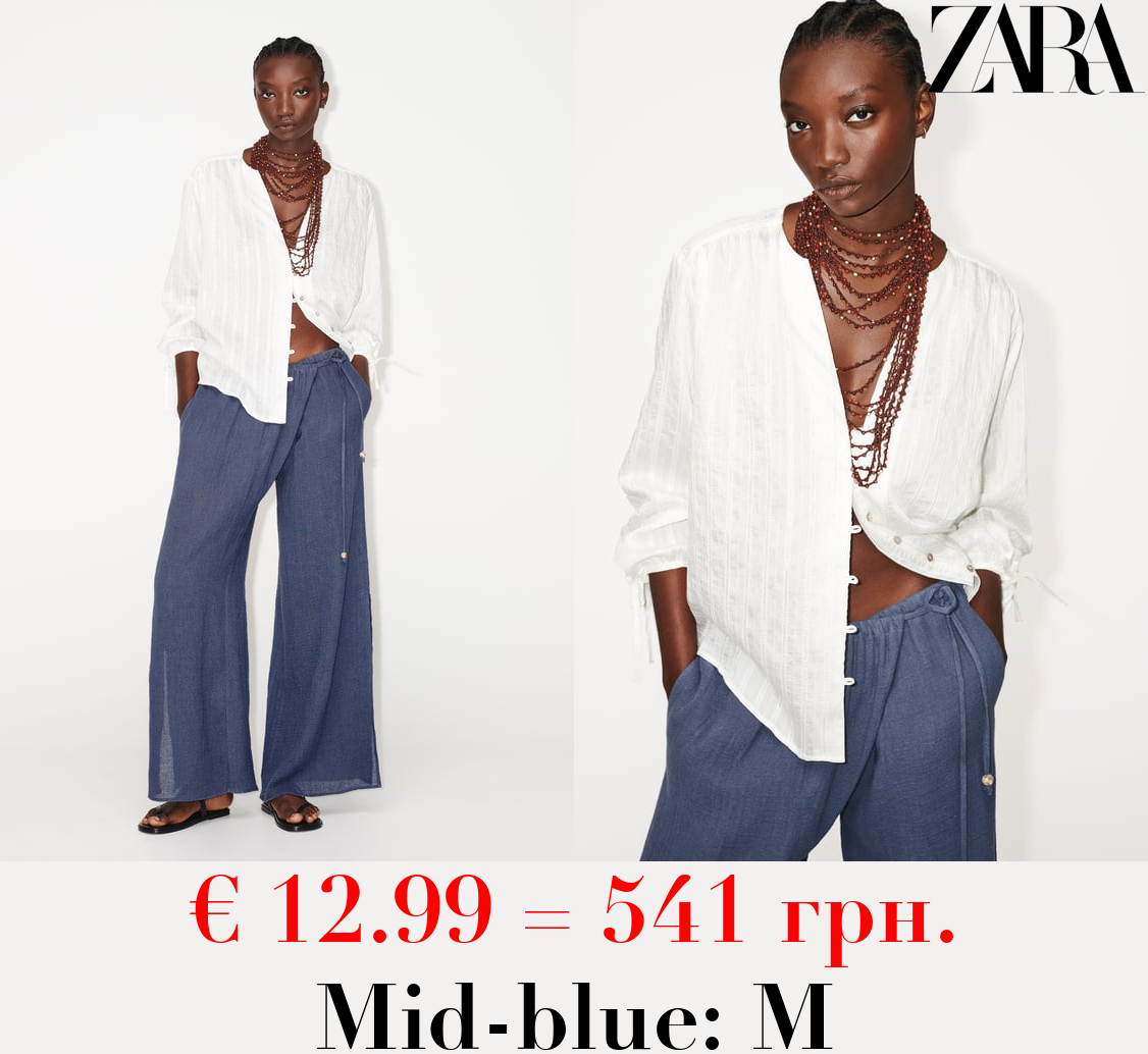 WIDE-LEG WRAP TROUSERS WITH SIDE OPENINGS
