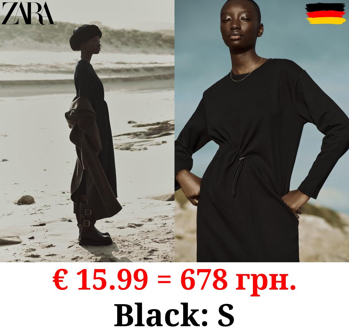 DRESS WITH GATHERED DETAIL AND STOPPER