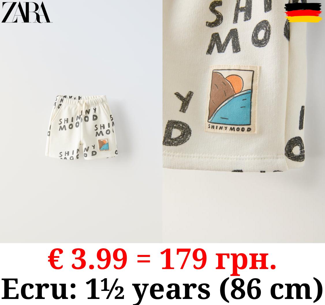 PRINTED BERMUDA SHORTS WITH SLOGAN AND LABEL