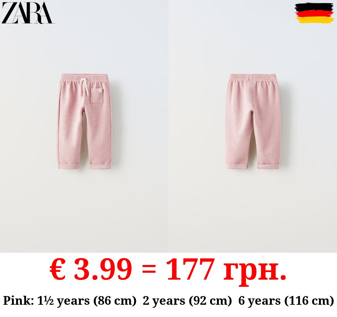 TEXTURED TROUSERS WITH LABEL