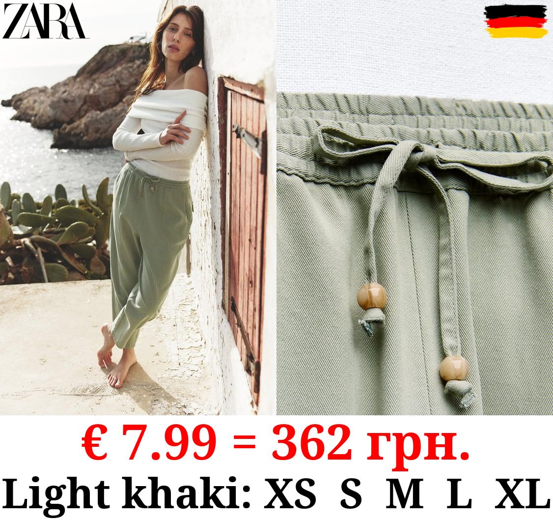 TROUSERS WITH AN ELASTICATED WAISTBAND