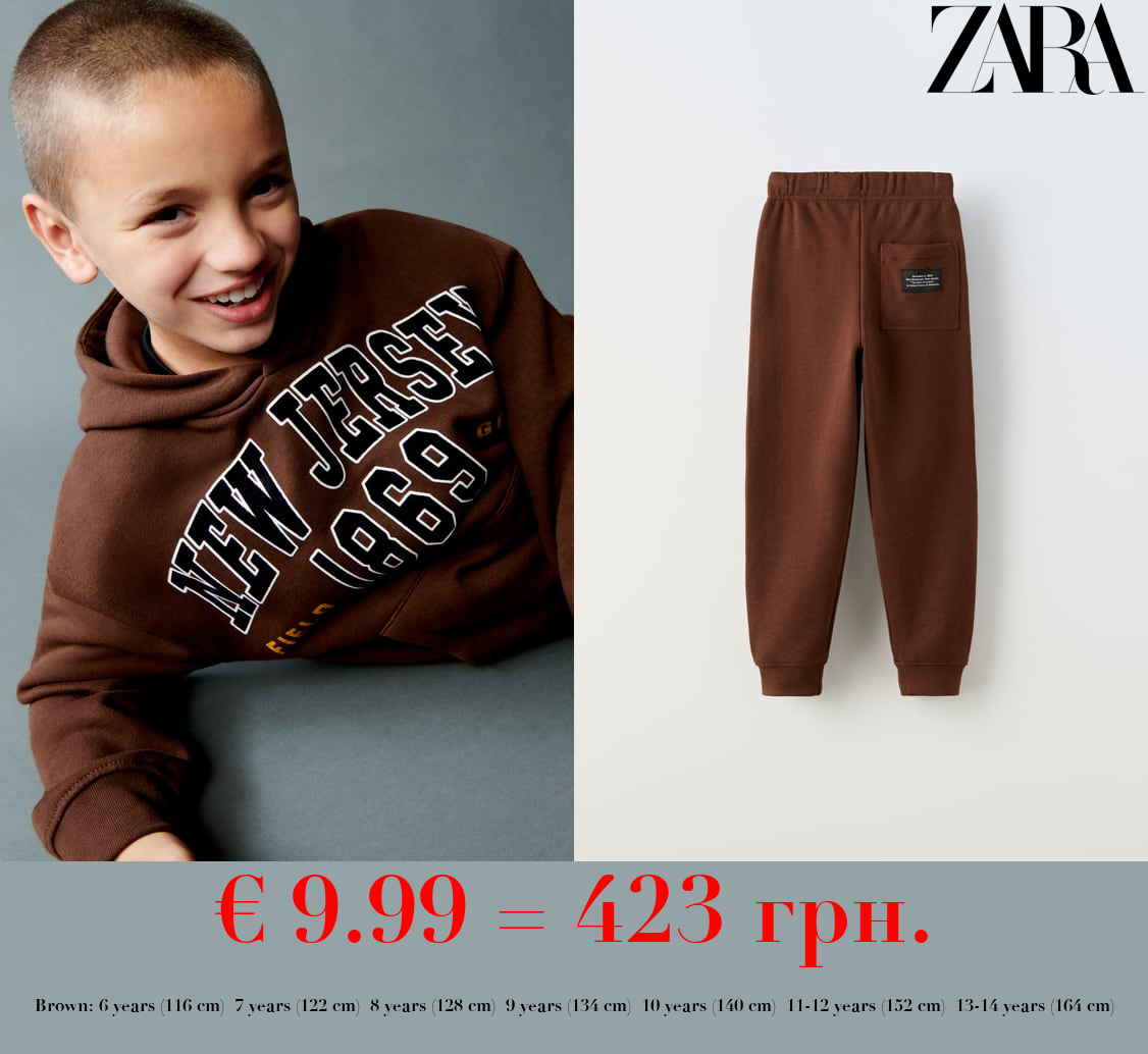 PLUSH TROUSERS WITH LABEL APPLIQUÉ