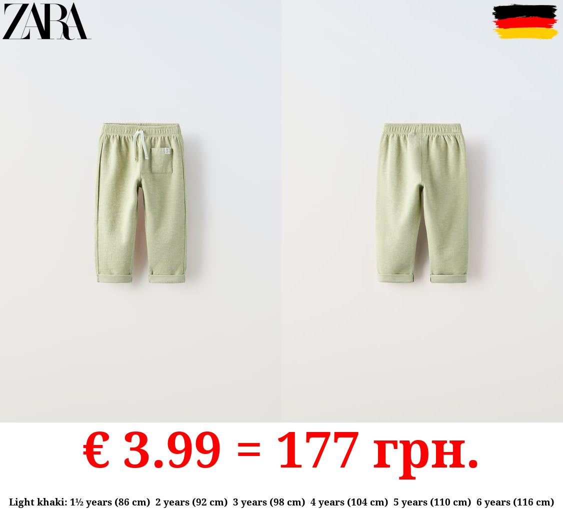 TEXTURED TROUSERS WITH LABEL