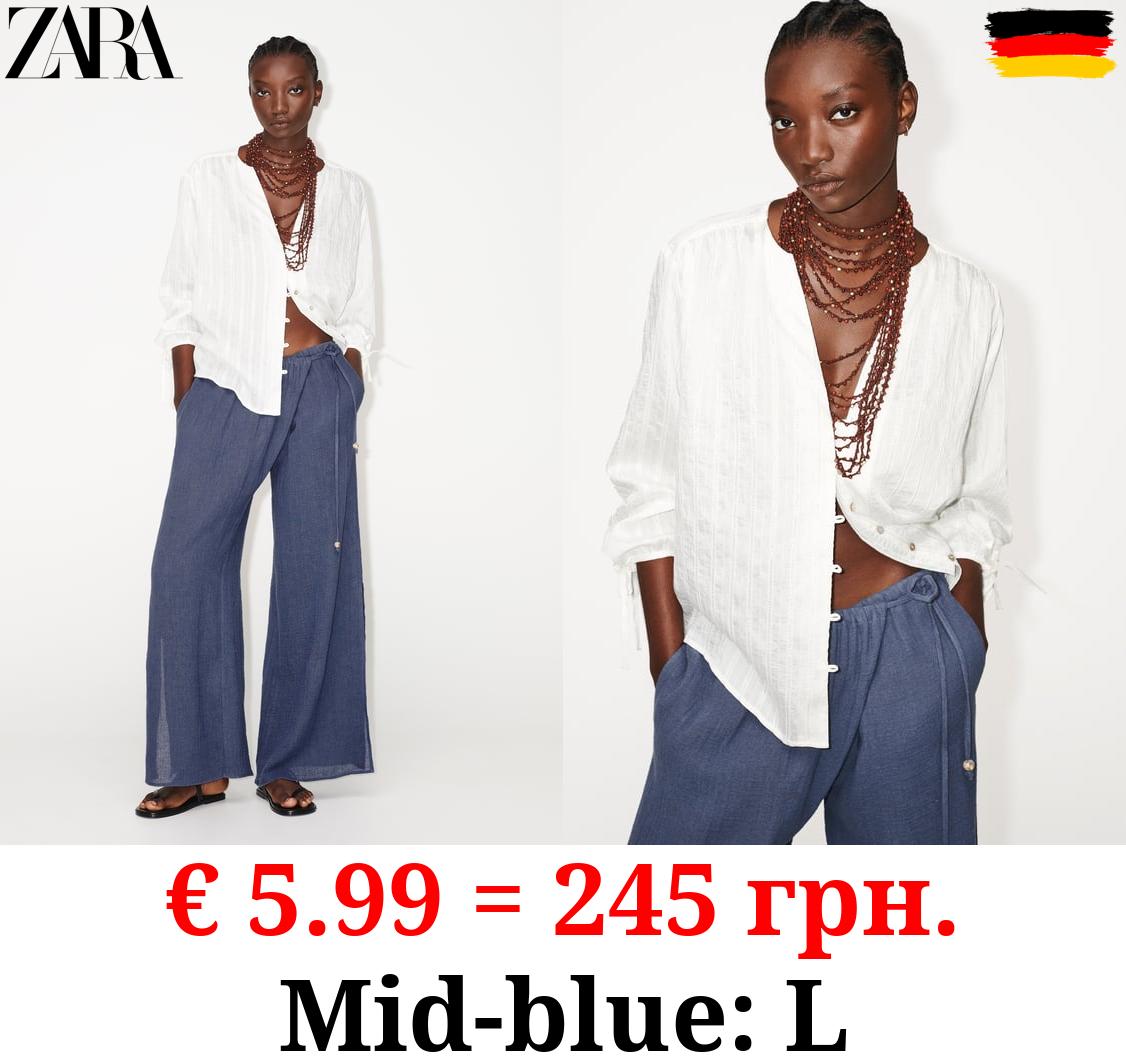 WIDE-LEG WRAP TROUSERS WITH SIDE OPENINGS