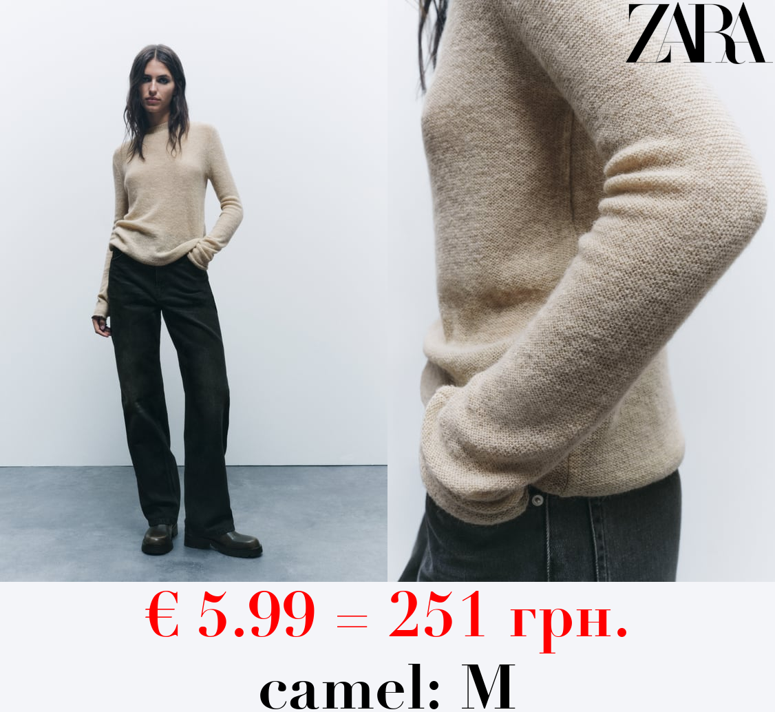 KNIT SWEATER WITH ROLLING TRIMS