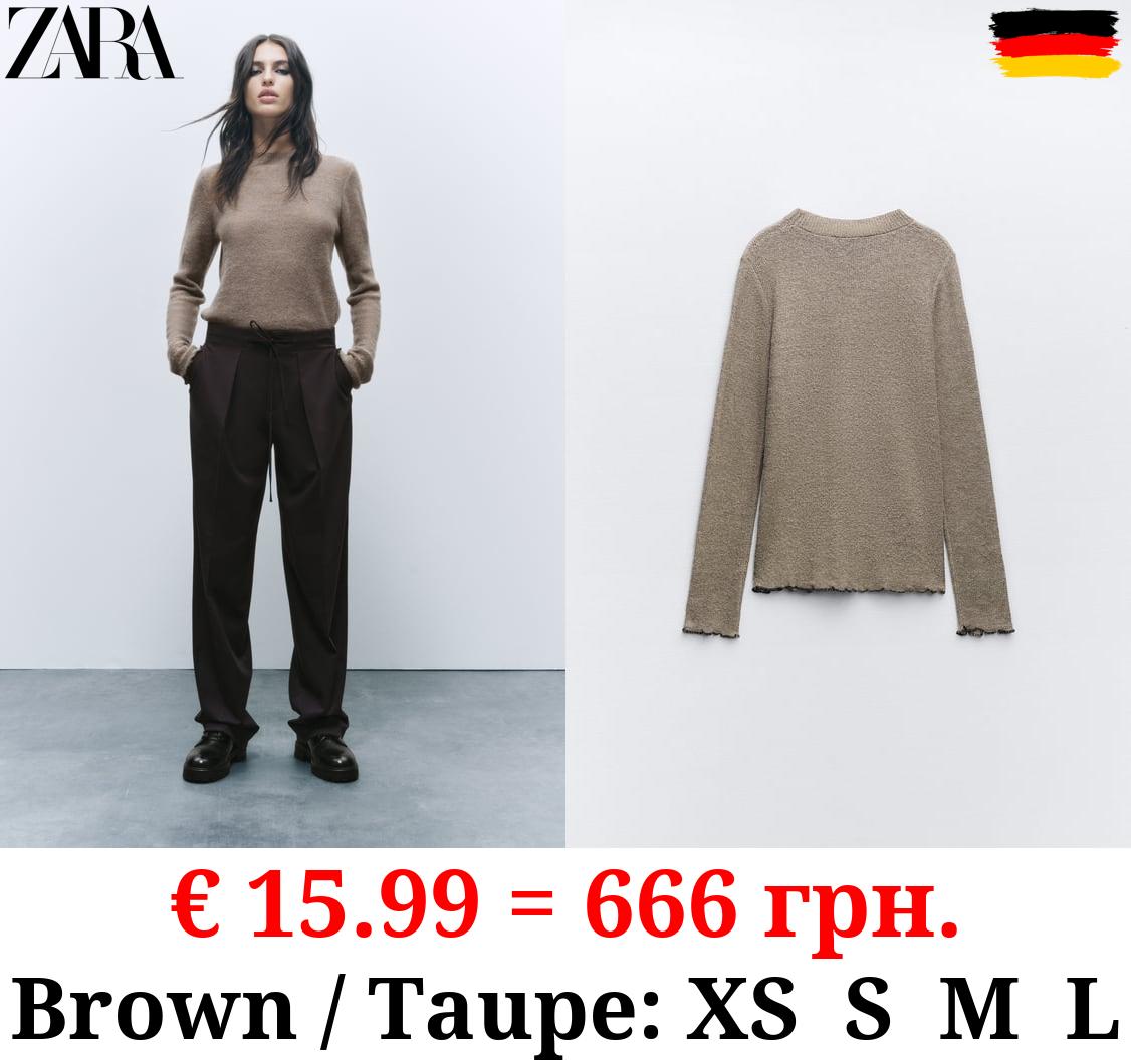 KNIT SWEATER WITH ROLLING TRIMS