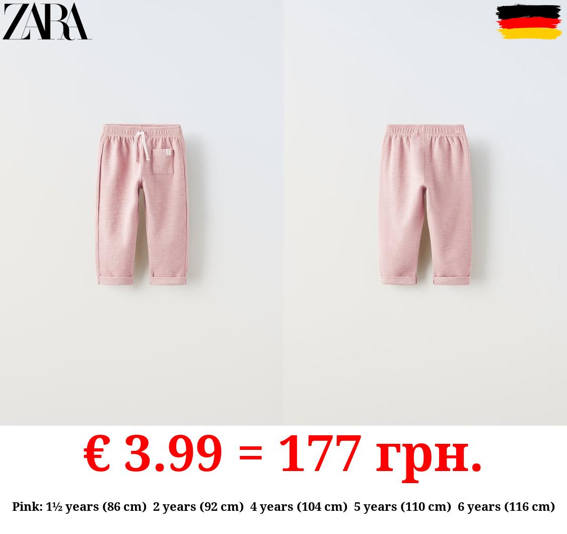 TEXTURED TROUSERS WITH LABEL