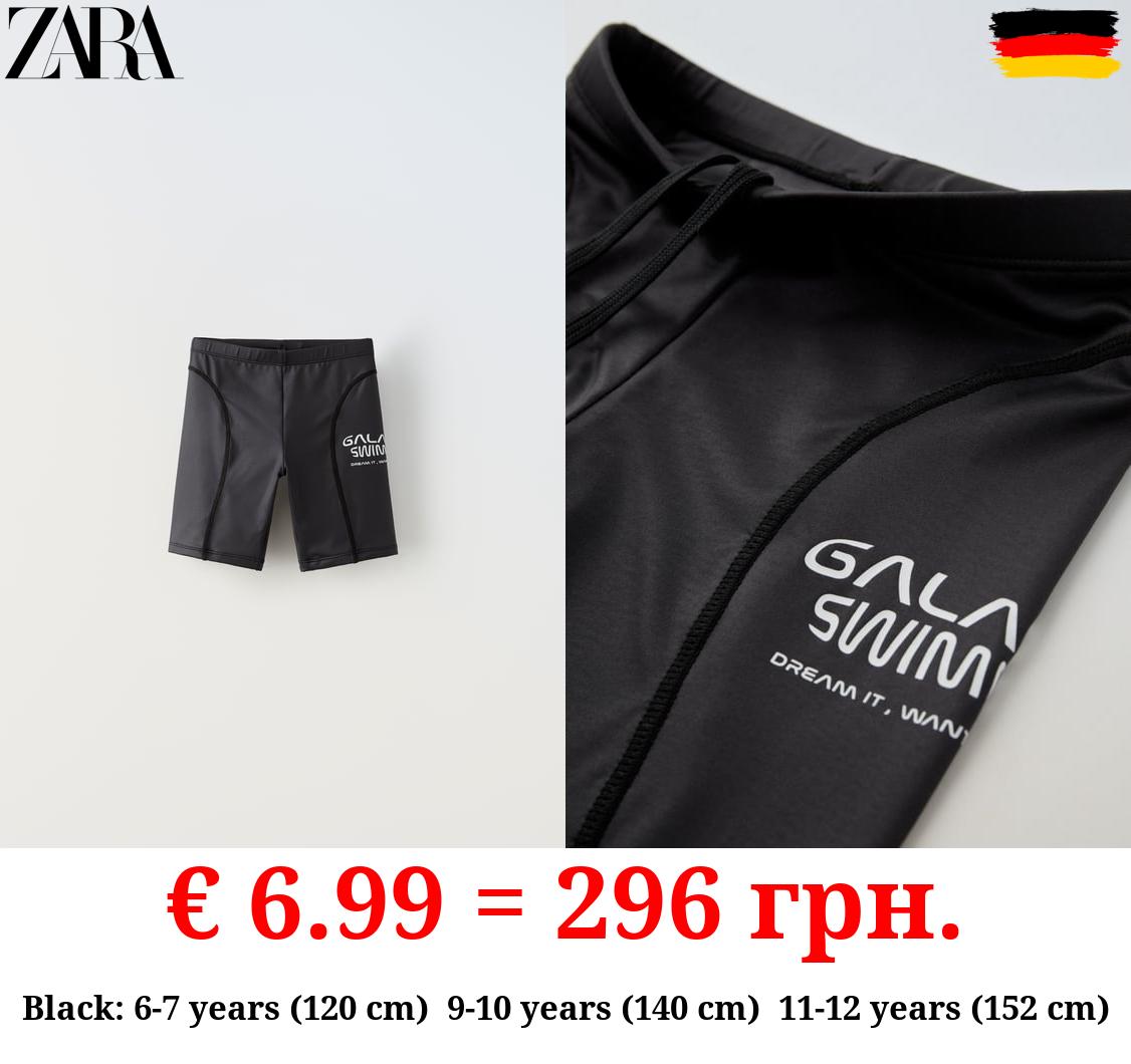 LONG SWIM SHORTS WITH SLOGAN