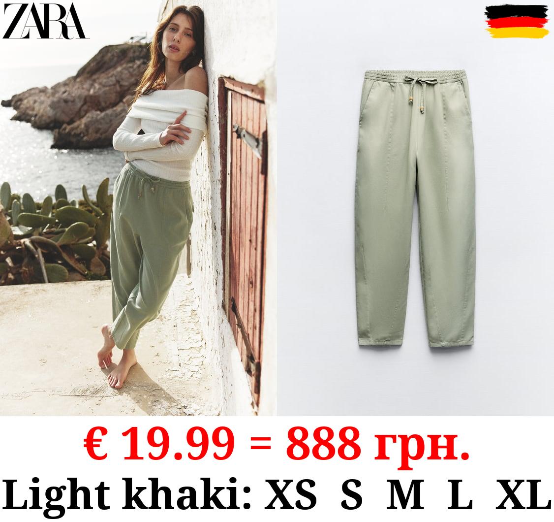 TROUSERS WITH AN ELASTICATED WAISTBAND