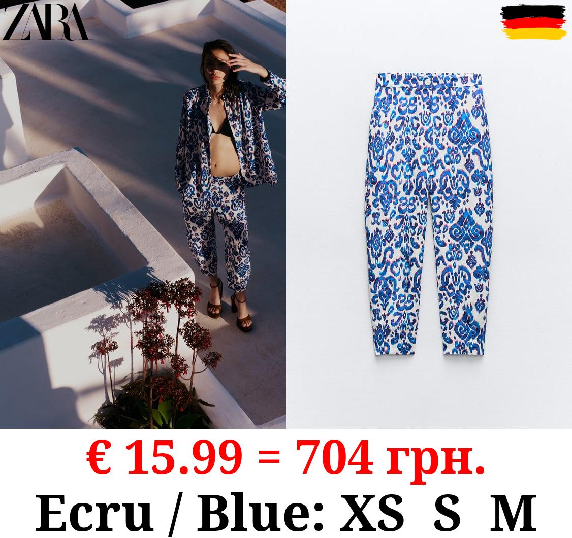 PRINTED CARROT-FIT TROUSERS